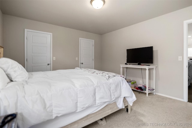 carpeted bedroom featuring baseboards