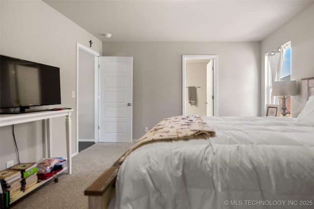 carpeted bedroom featuring ensuite bathroom