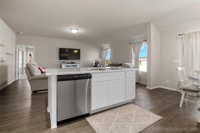 kitchen featuring stainless steel dishwasher, open floor plan, a kitchen island with sink, white cabinetry, and a sink