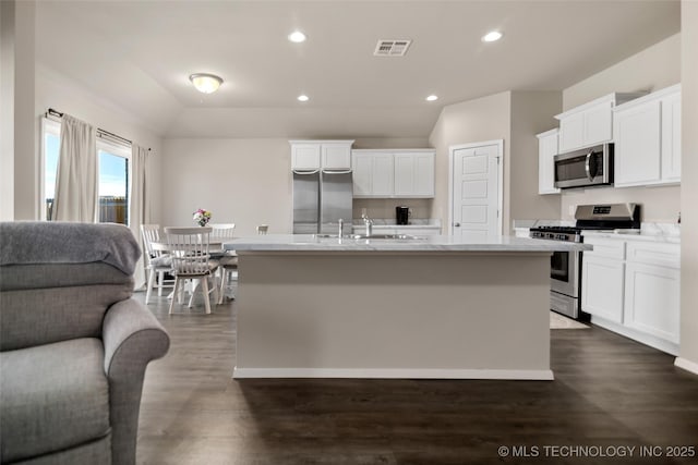 kitchen featuring visible vents, white cabinets, an island with sink, stainless steel appliances, and recessed lighting