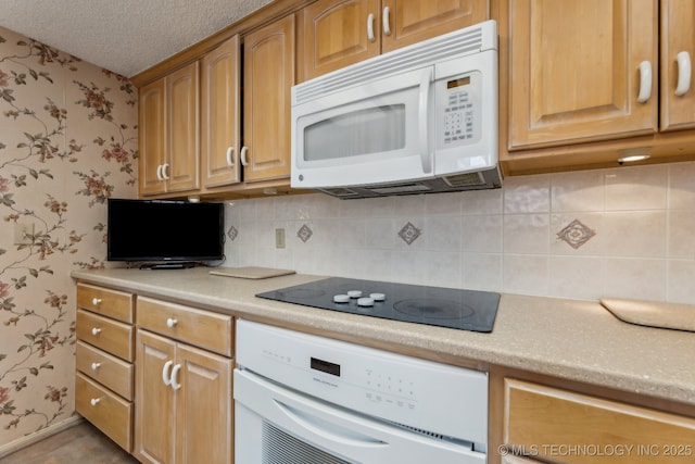 kitchen with white appliances, decorative backsplash, and a textured ceiling