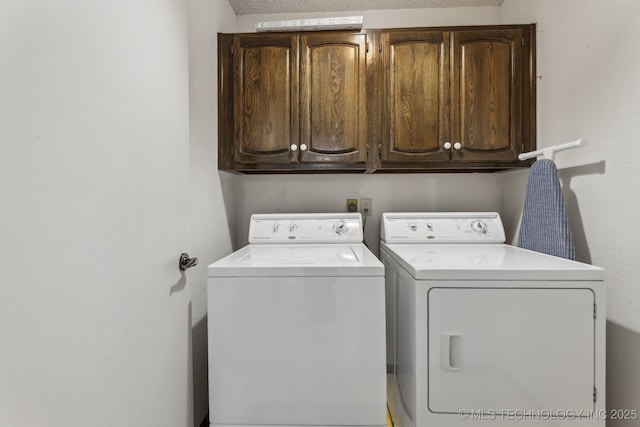 laundry room with cabinets and washing machine and clothes dryer