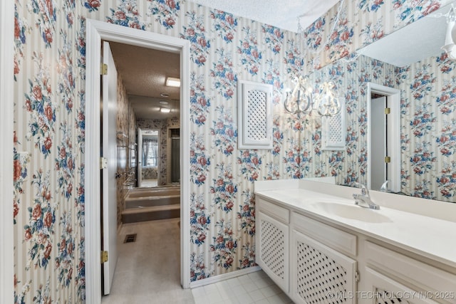 bathroom with vanity and a textured ceiling