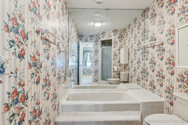 bathroom with a textured ceiling and toilet