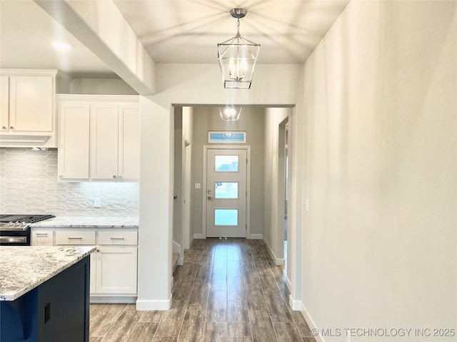 interior space featuring wood-type flooring and a chandelier