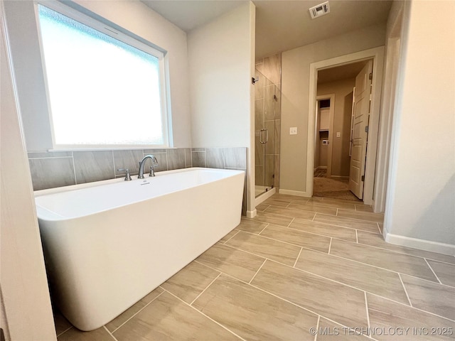 bathroom featuring plus walk in shower