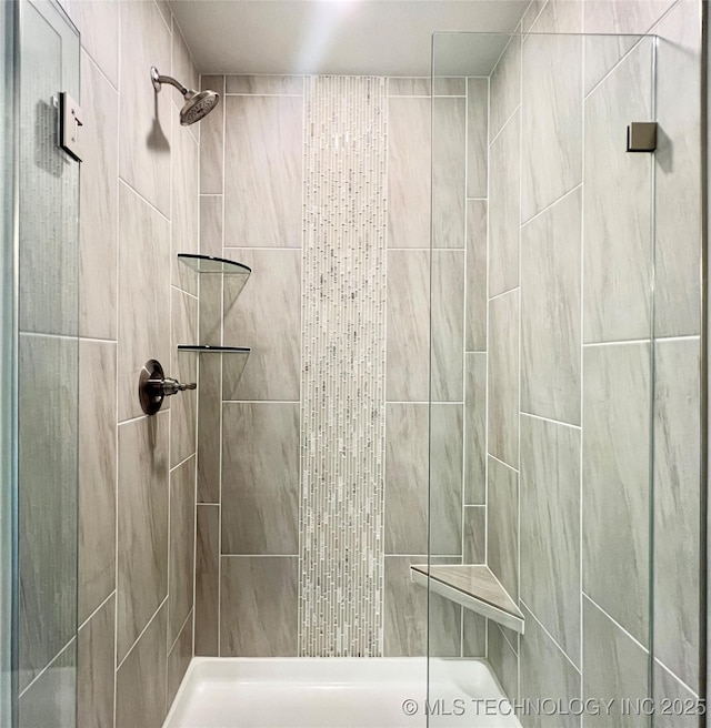 bathroom with a tile shower