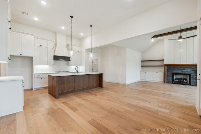 2722 E 134th Cir, Bixby, OK 74008 - kitchen featuring premium range hood, light wood finished floors, white cabinets, recessed lighting, and vaulted ceiling