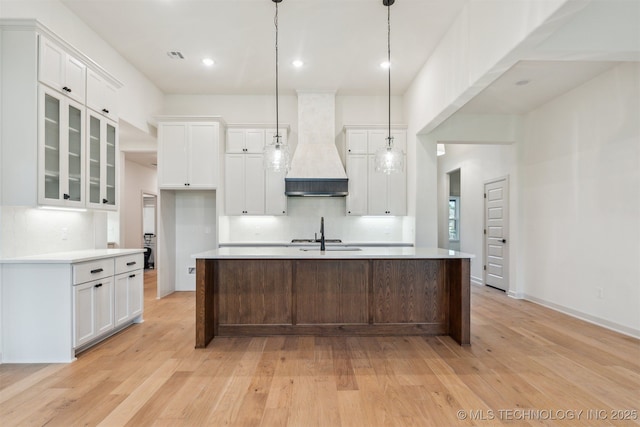 2722 E 134th Cir, Bixby, OK 74008 - kitchen featuring custom range hood, light wood-type flooring, white cabinetry, backsplash, and recessed lighting