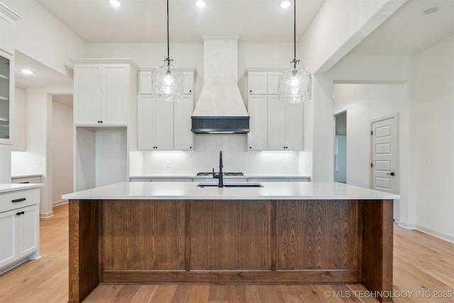2722 E 134th Cir, Bixby, OK 74008 - kitchen with premium range hood, light wood-type flooring, white cabinets, light countertops, and recessed lighting