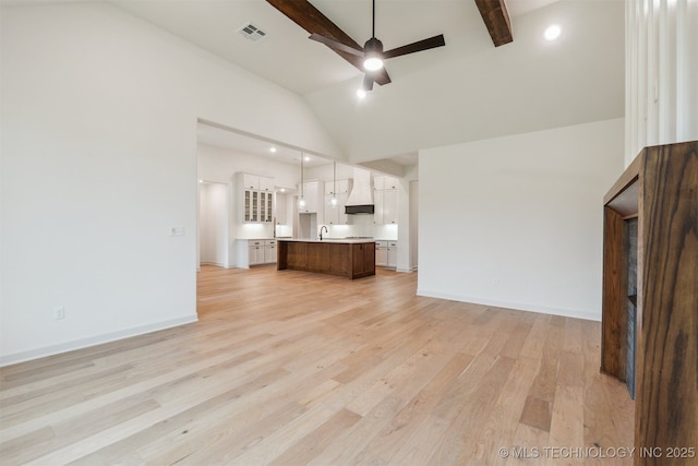 2722 E 134th Cir, Bixby, OK 74008 - unfurnished living room featuring a ceiling fan, high vaulted ceiling, light wood-style flooring, beam ceiling, and recessed lighting