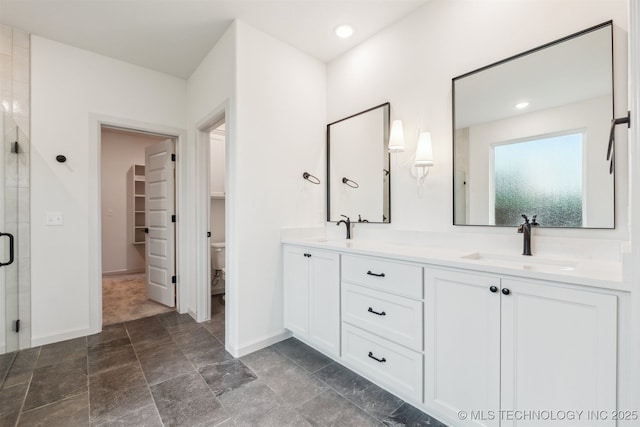 2722 E 134th Cir, Bixby, OK 74008 - bathroom with a stall shower, double vanity, stone finish floors, and a spacious closet