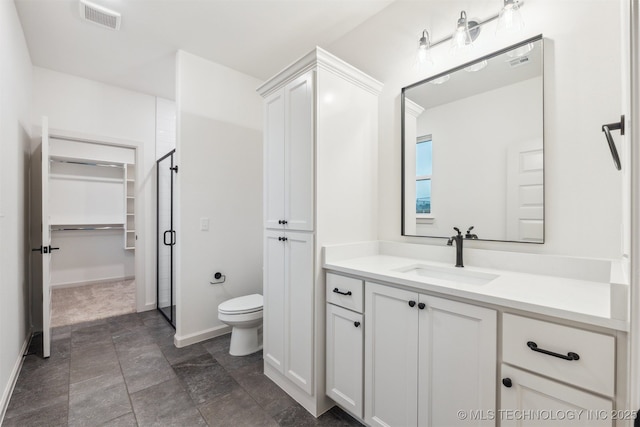 2722 E 134th Cir, Bixby, OK 74008 - full bath with vanity, a walk in closet, stone finish flooring, and an enclosed shower