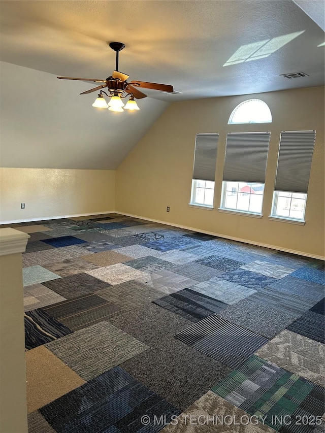 bonus room with lofted ceiling, ceiling fan, and carpet