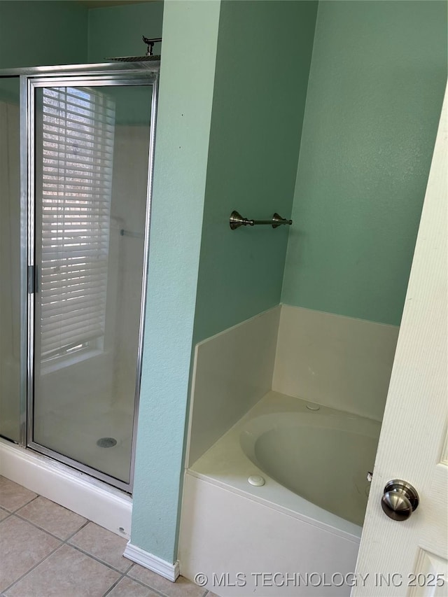 bathroom featuring shower with separate bathtub and tile patterned flooring