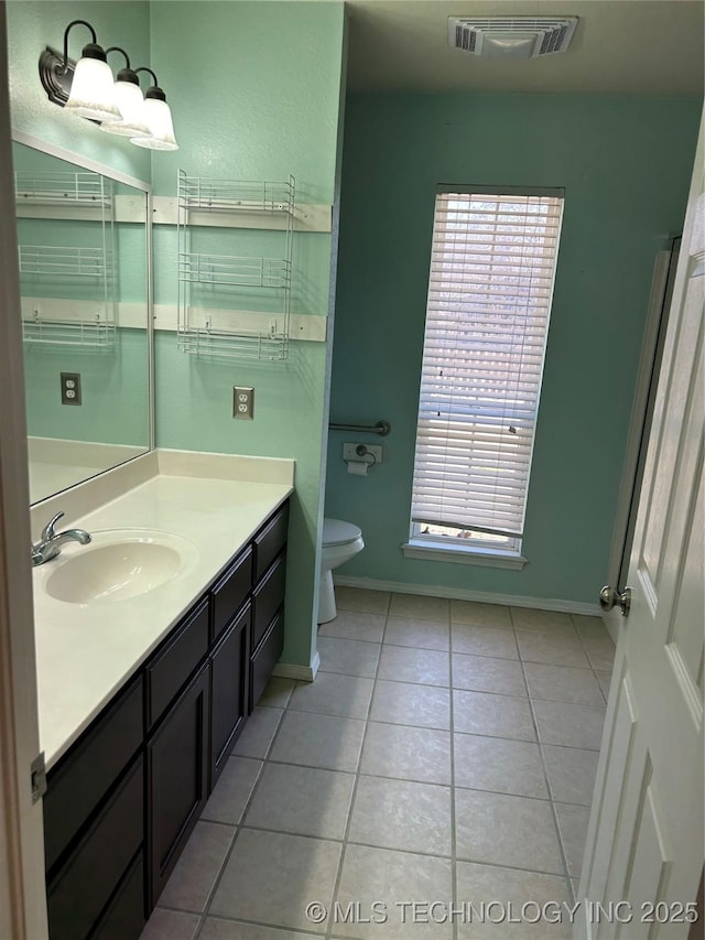 bathroom with vanity, tile patterned floors, and toilet