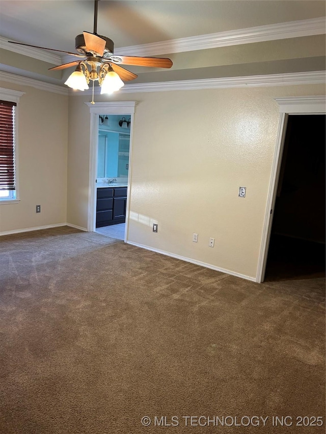 carpeted spare room featuring ceiling fan and ornamental molding