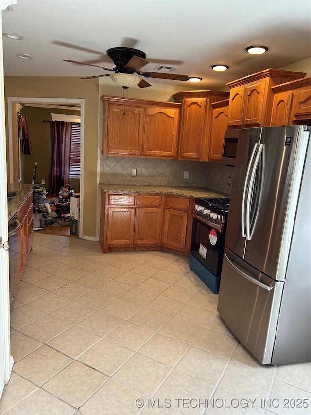 kitchen with stainless steel appliances, light tile patterned floors, ceiling fan, and decorative backsplash