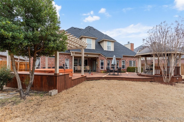 back of property featuring a pergola, a wooden deck, and a gazebo