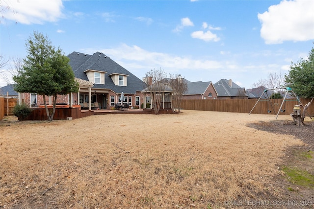 view of yard with a deck and a playground