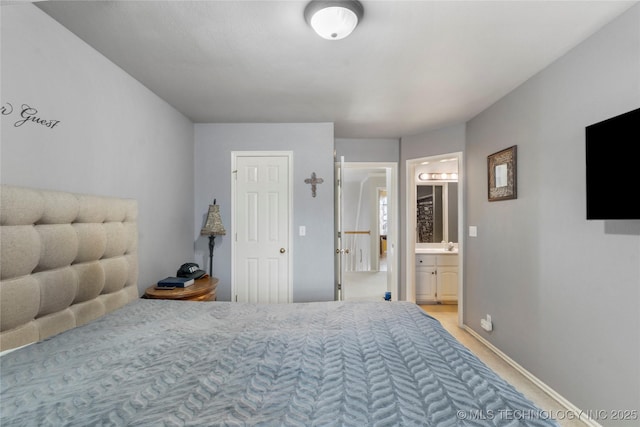 carpeted bedroom featuring ensuite bath