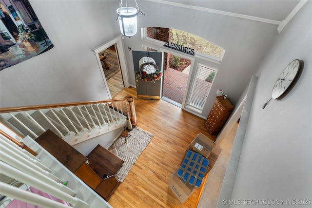 entryway featuring ornamental molding and hardwood / wood-style floors