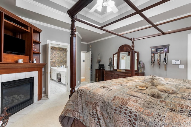 carpeted bedroom featuring crown molding and a tile fireplace