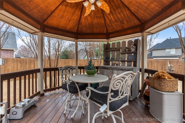 wooden terrace featuring a gazebo