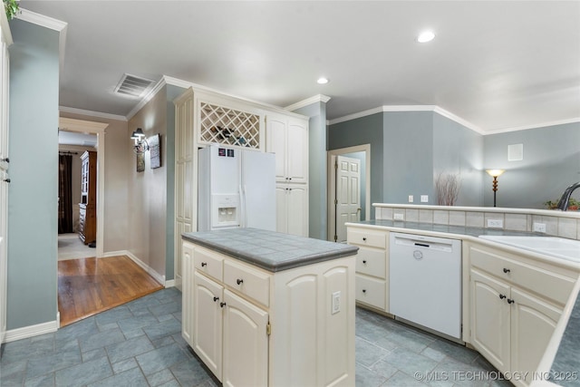 kitchen featuring sink, white appliances, tile countertops, and ornamental molding