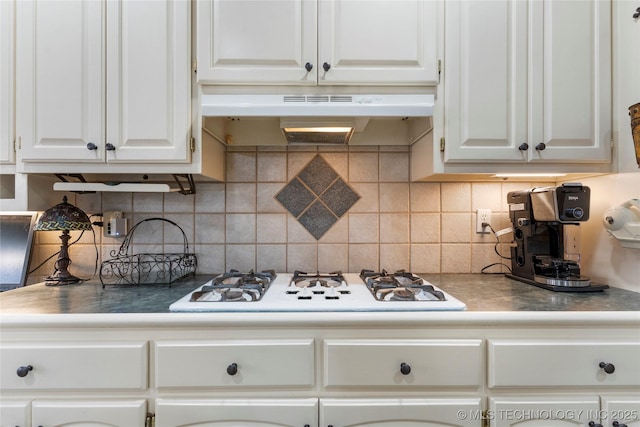 kitchen with white cabinetry, decorative backsplash, and white gas cooktop