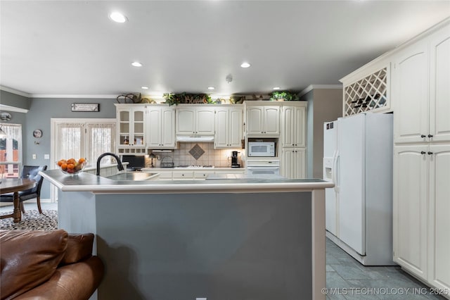 kitchen featuring crown molding, white appliances, and white cabinets