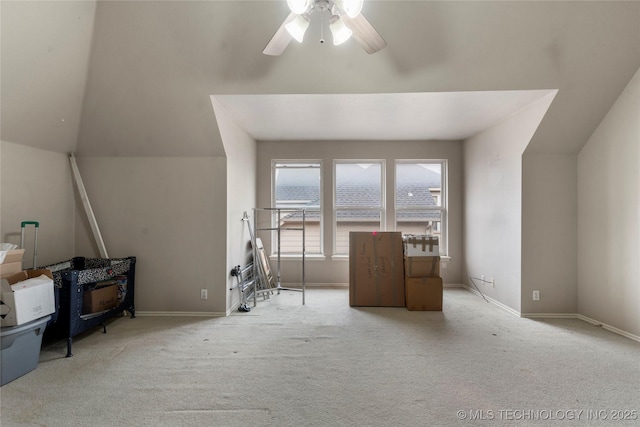 bonus room featuring light carpet and ceiling fan