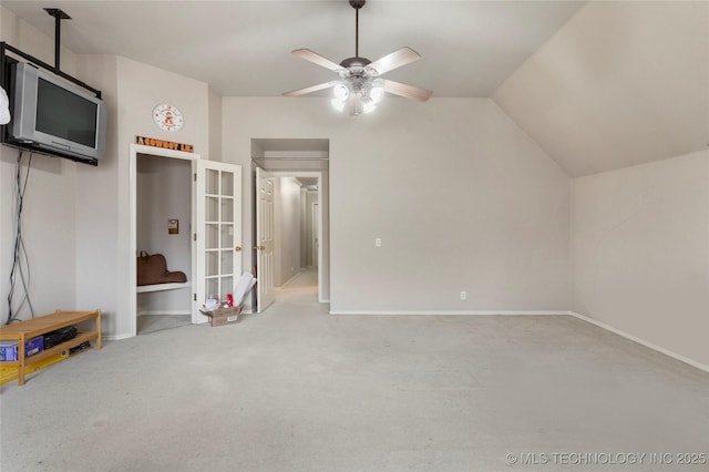 interior space with vaulted ceiling, carpet, and ceiling fan