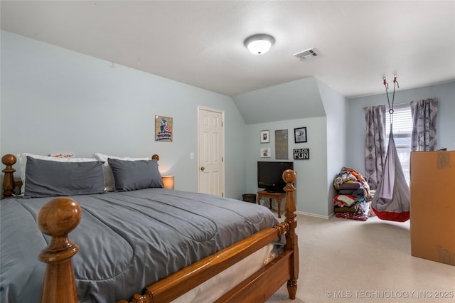 carpeted bedroom with lofted ceiling