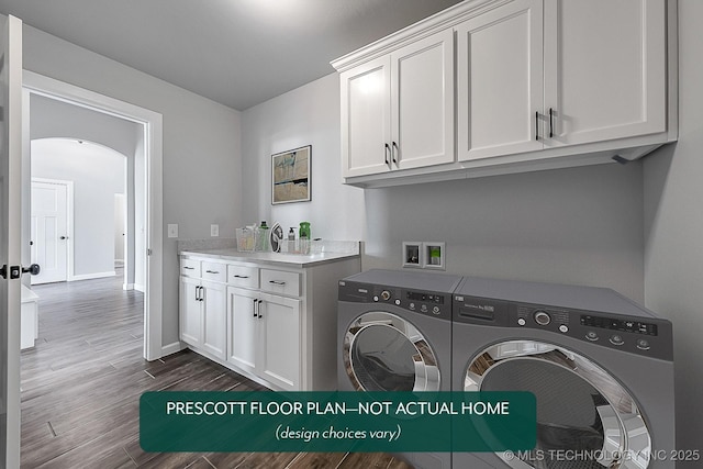 clothes washing area featuring dark hardwood / wood-style flooring, cabinets, and washer and dryer