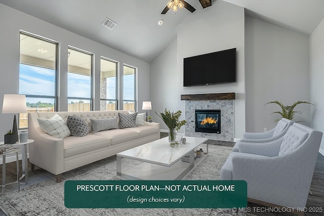 living room featuring ceiling fan, wood-type flooring, a wealth of natural light, and a fireplace