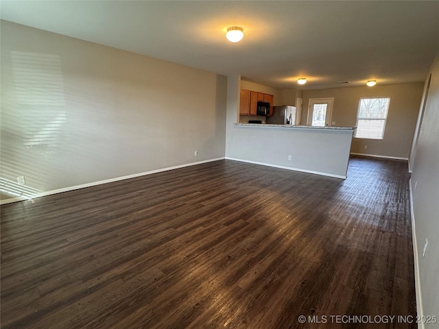 unfurnished living room with dark hardwood / wood-style floors