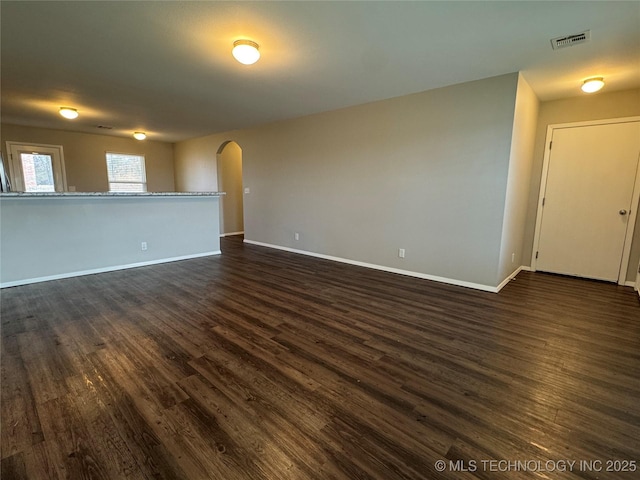 unfurnished room featuring dark wood-type flooring