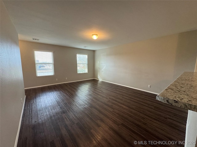 unfurnished room featuring dark hardwood / wood-style flooring