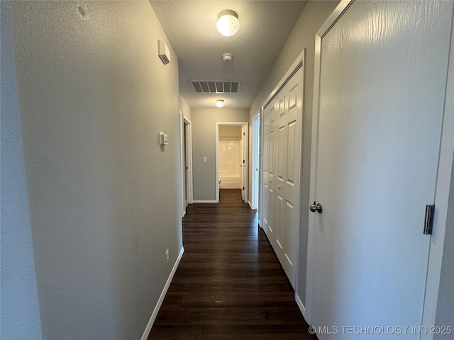 hallway with dark wood-type flooring