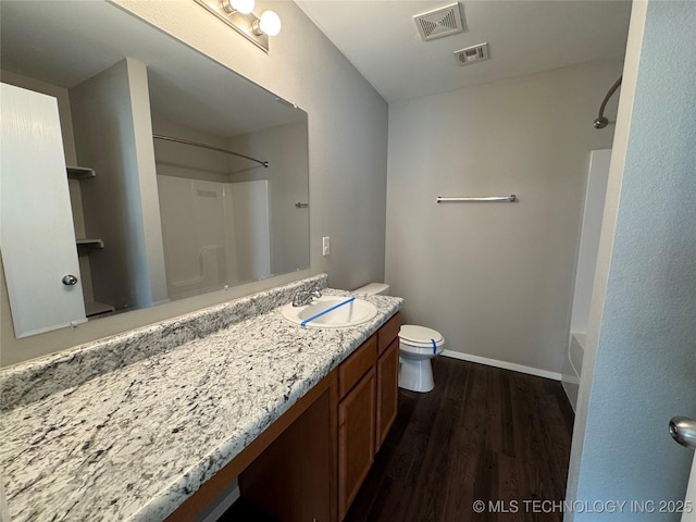 full bathroom featuring vanity, hardwood / wood-style floors, toilet, and shower / bath combination