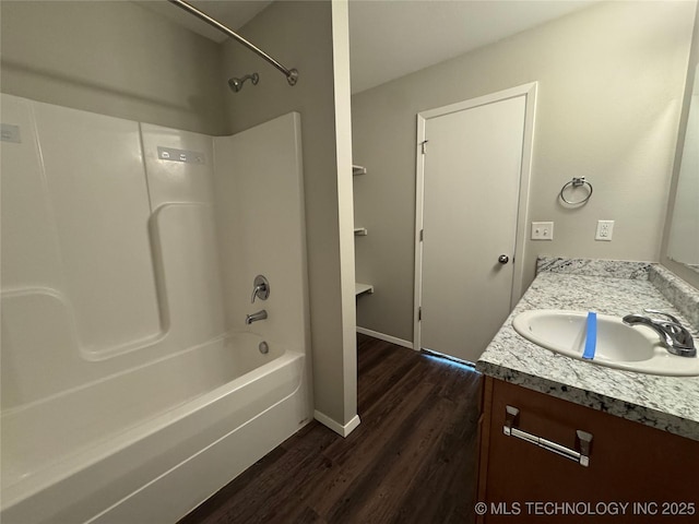 bathroom featuring hardwood / wood-style flooring, vanity, and bathtub / shower combination