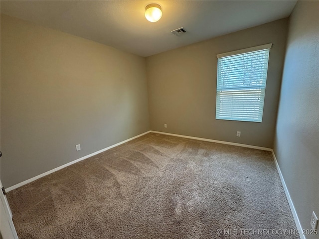 spare room featuring carpet floors