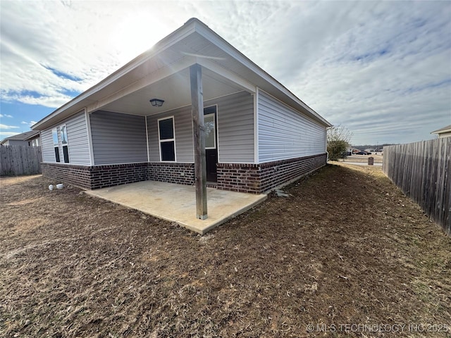 view of side of home featuring a patio