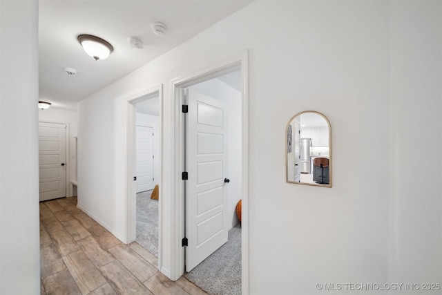 hallway with light hardwood / wood-style floors