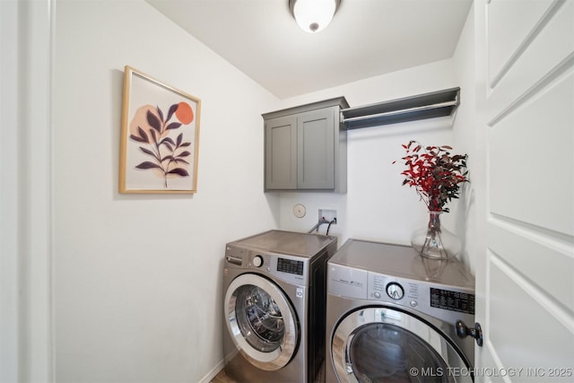 washroom featuring cabinets and washer and dryer