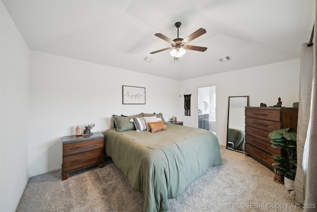 carpeted bedroom with ceiling fan, ensuite bathroom, and vaulted ceiling