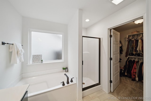 bathroom featuring shower with separate bathtub