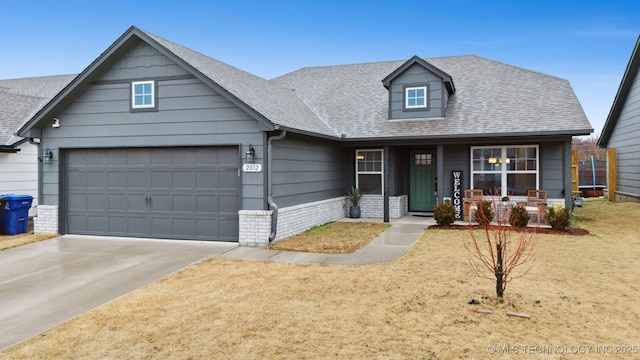 view of front of house with a garage, a porch, and a front lawn