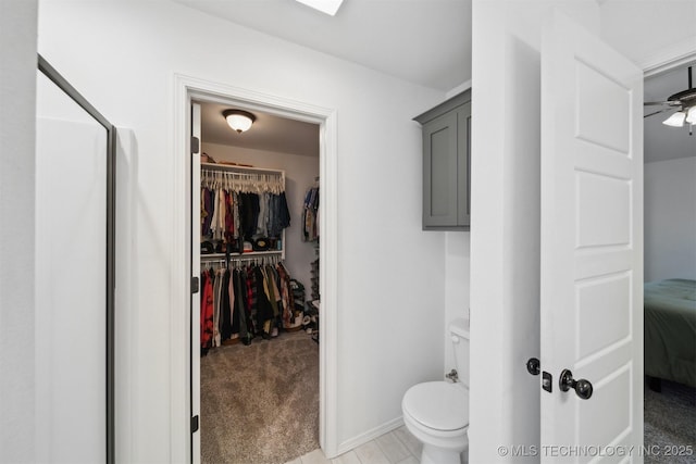 bathroom with ceiling fan and toilet